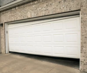 Garage Hinges off track on broken garage door during emergency garage door repair service on garage in Round Rock, TX
